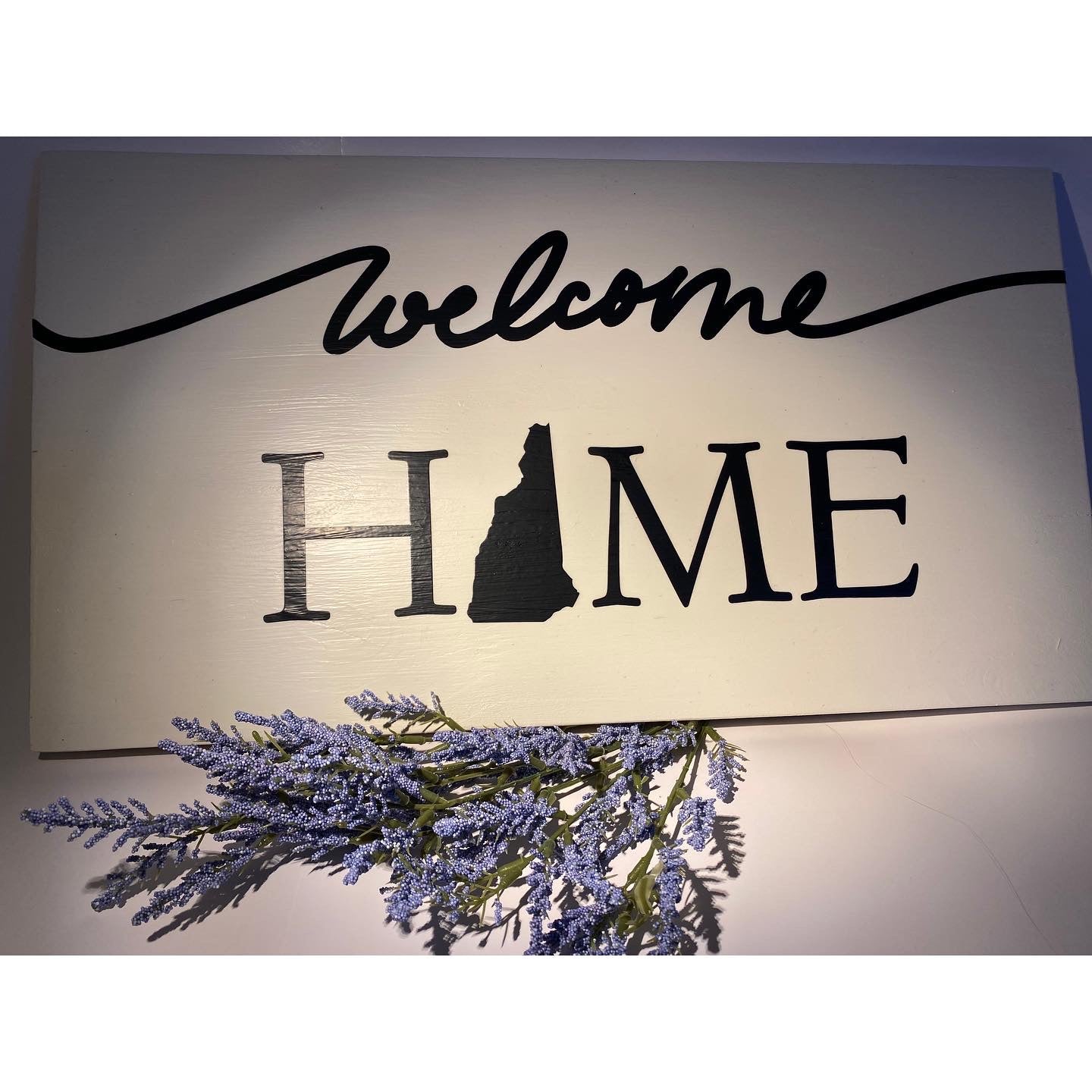 Welcome Home N.H hanging sign
